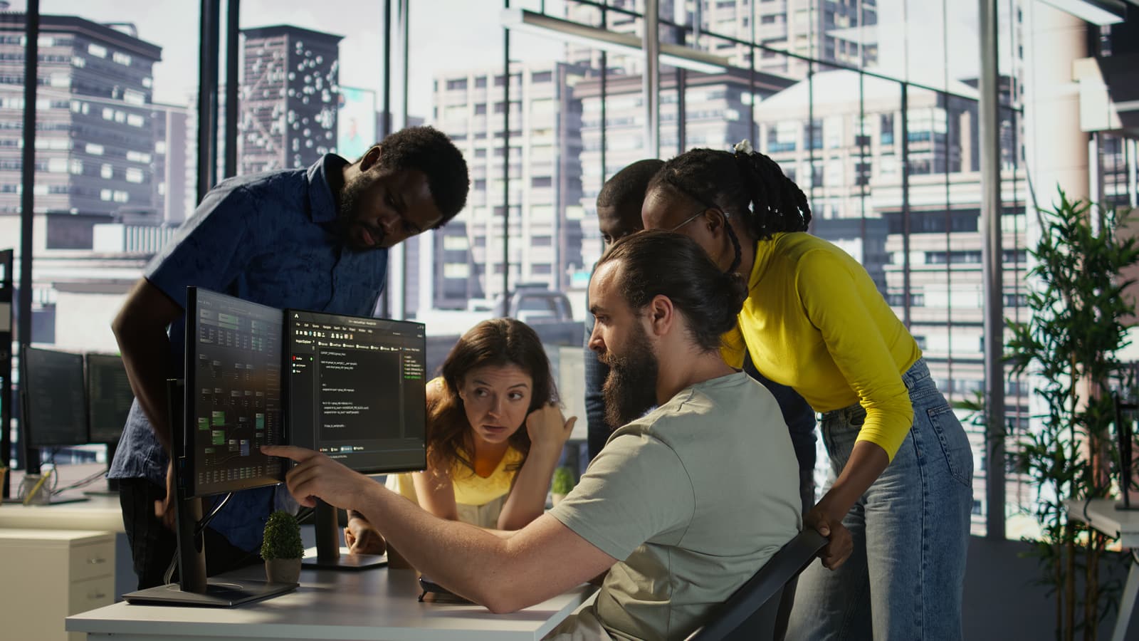 Developers reviewing code together at a monitor