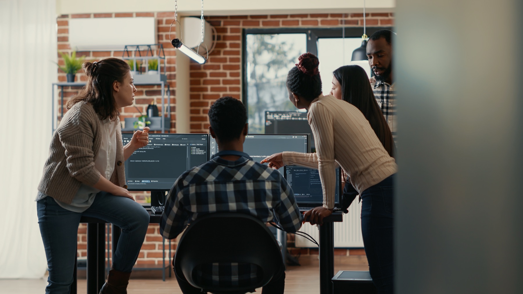 The Rhytmelo team reviewing code together at their desks
